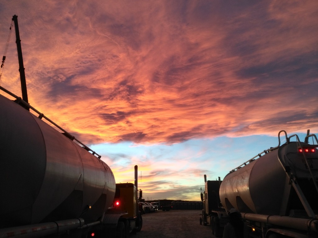 Tanker trucks at sunset in the Permian Basin